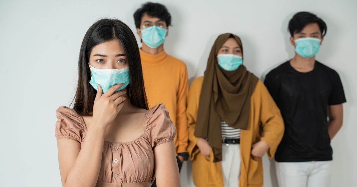 4 people wearing face coverings